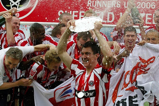 United skipper Chris Morgan, his teammates and coaching staff celebrate promotion to the Premier League in April 2006.