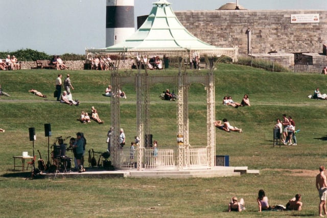 Crowds enjoy the sunshine at the bandstand in Southsea Common in June 1998.