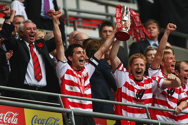 Brian Stock lifts the trophy as chairman John Ryan celebrates following Doncaster Rovers' famous win over Leeds in the League One play-off final at Wembley in 2008.