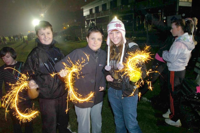 David Grint, Conor Dickinson and Sophie Lee pictured with sparklers at a 2008 display.