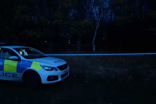 A dog is reported to have been shot by police gunmen after attacking a woman at a Sheffield beauty spot today. The picture shows police guarding the scene this evening