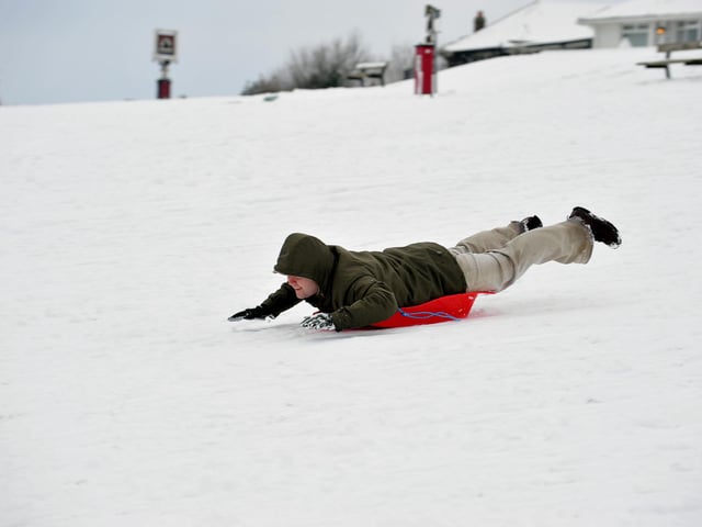 Matthew Reed sledging in the snow on top of Portsdown Hill.