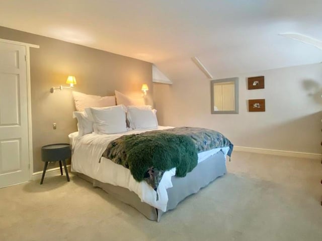 A delightful master bedroom, which is at the back of the property and has double-glazed windows overlooking the garden. It features a walk-in wardrobe and a range of built-in hanging and storage facilities.