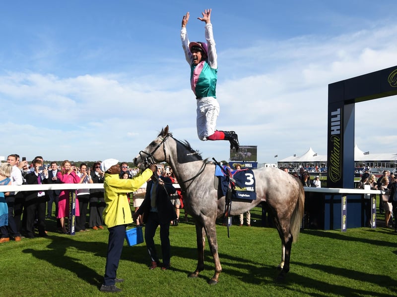 Frankie Dettori riding Logician celebrates with his trademark flying dismount after winning the William Hill St Leger Stakes during St Leger Day at Doncaster Racecourse on September 14, 2019 . 