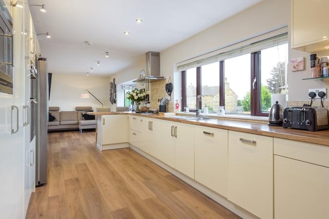 The kitchen is sleek and modern and each appliance reflects the incoming light all over the room. It is spacious, with plenty of worktop space to cook on and a small breakfast bar at the end for the mornings.