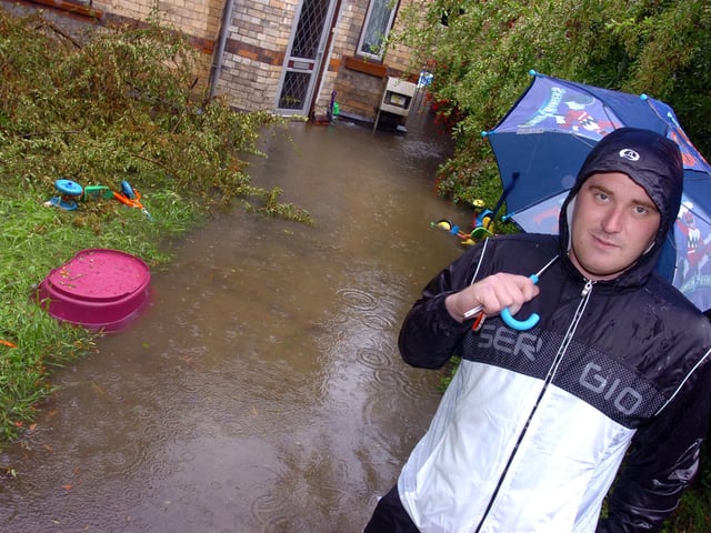 Lee Neath outside his Whittington Street, Doncaster, rented home which is surrounded by flood water. It was flooded during the last heavy downpour of rain, and he was expecting it to be flooded once again in 2007