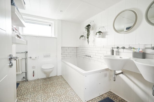 The large master bathroom has a full-sized bath, separate shower, double sinks and underfloor heating