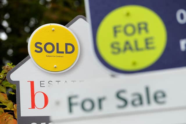 Sold and for sale signs as house prices in Sheffield defy a drop in the national market