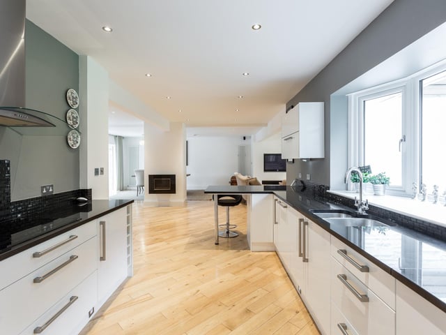 The kitchen looks out into the dining and living room area.
