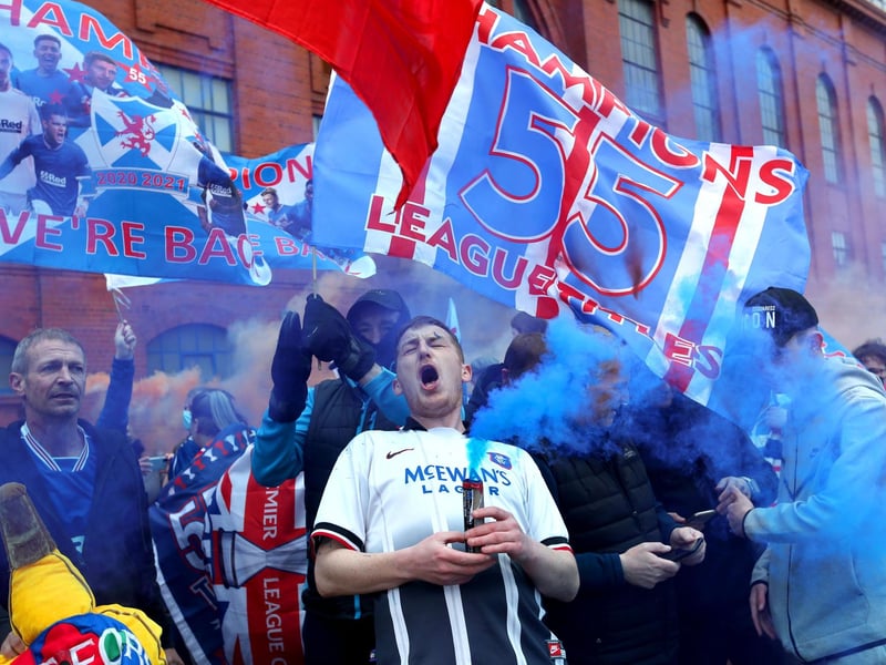 Rangers fans celebrate outside of the Ibrox Stadium after Rangers win the Scottish Premiership title.