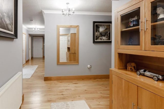 The substantial, L-shaped entrance hallway is attractive in itself, with its solid oak floor, two radiators and coving to the ceiling. It even has its own personal door through to the double garage.