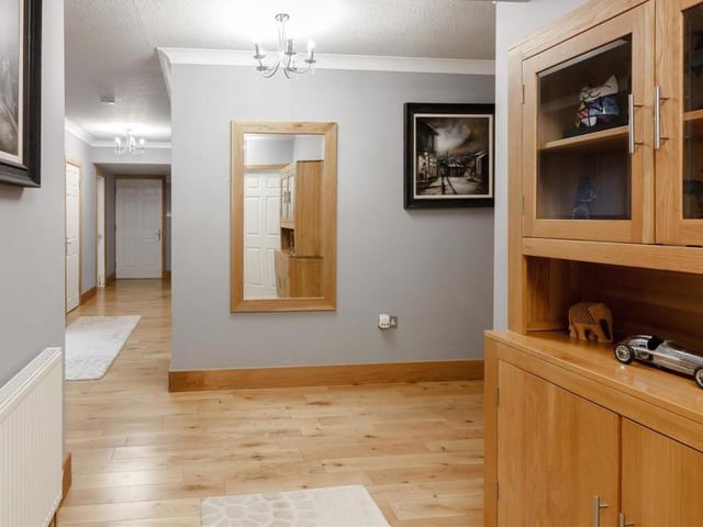 The substantial, L-shaped entrance hallway is attractive in itself, with its solid oak floor, two radiators and coving to the ceiling. It even has its own personal door through to the double garage.
