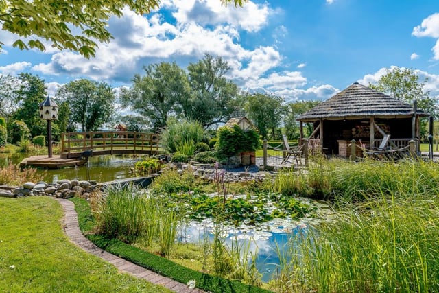 The property is situated within approximately four acres of private gardens which encompass a stone flagged seating terrace, a large pond, wooden bridge and beautifully manicured lawns.
