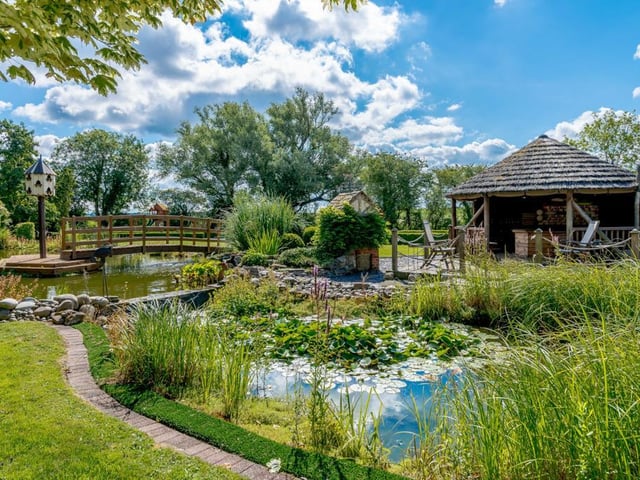 The property is situated within approximately four acres of private gardens which encompass a stone flagged seating terrace, a large pond, wooden bridge and beautifully manicured lawns.