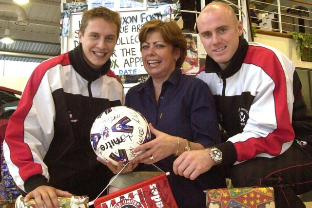 Sheffield United players, Phil Jagielka, left and Robert Page joined Dixons business centre administrator June Rogers in giving a signed ball to Dixons Ford shoebox appeal in 2002.