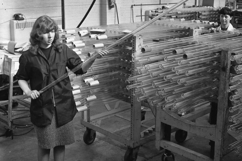 Workers with Pyrex glass tubes in a scene from 1966.