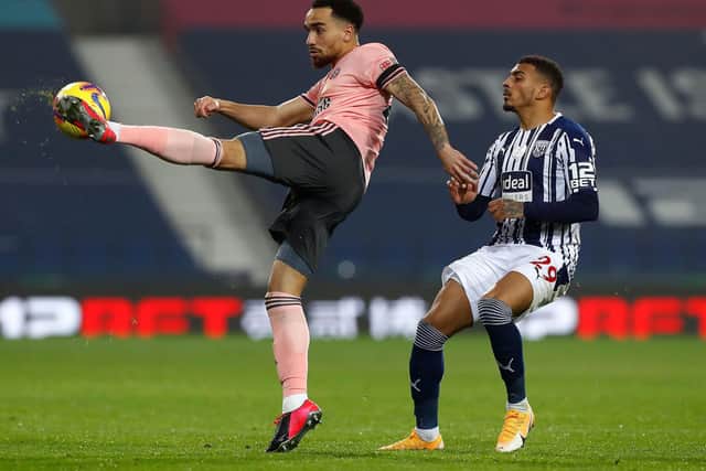 West Bromwich Albionstriker Karlan Grant (R) closes in on Sheffield United's Kean Bryan during the English Premier League football match between West Bromwich Albion and Sheffield United at The Hawthorns: JASON CAIRNDUFF/POOL/AFP via Getty Images