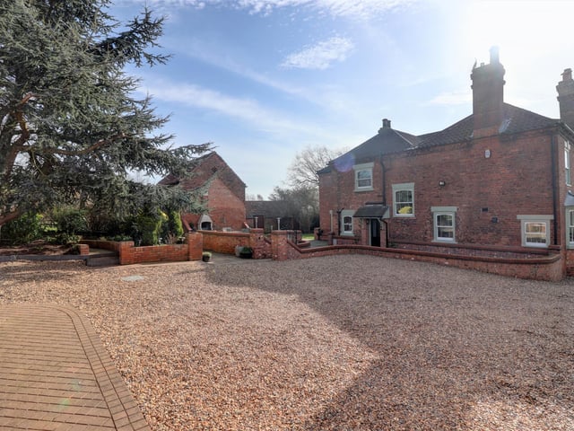 Double electric remote-controlled wrought iron gates lead onto the pebbled driveway which provides access to the front and rear of the property.