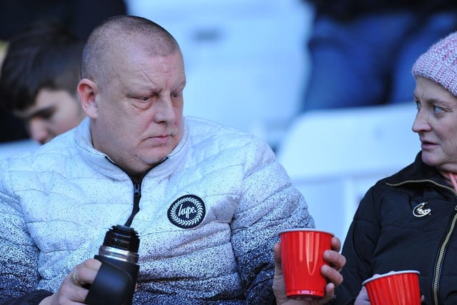 Two Sunderland fans enjoy a cup of something warm at the Stadium of Light.