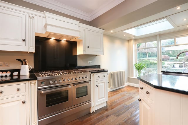 The kitchen is fitted with shaker style cabinets and skylight.