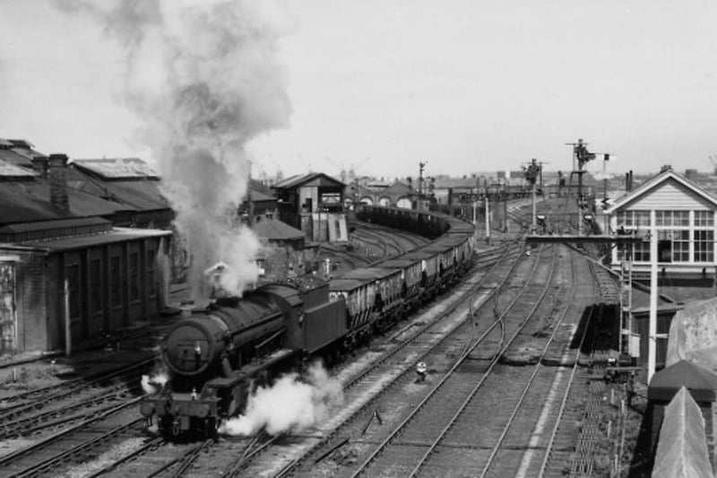 A steam locomotive hauls coal wagons past the Newburn Bridge signal box in June 1966, with the locomotive shed in the background. Photo: Hartlepool Library Service