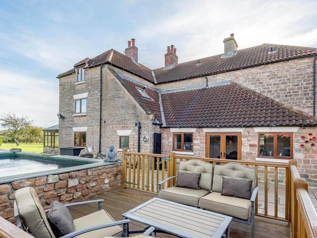 The property also boasts this pleasant area containing an enclosed decked patio and even a large, stone-built pond. Charming, wouldn't you say?
