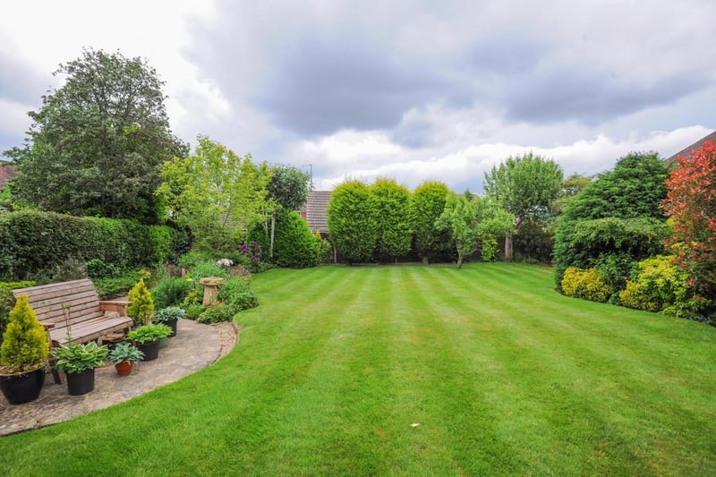 Zoopla says the property has a "stunning landscaped garden with patio, lawn and stocked borders".
