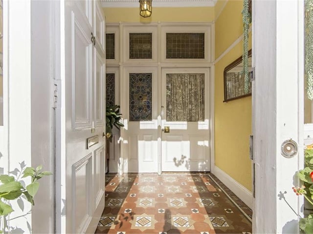 Vestibule with stained-glass windows and original floor tiling.