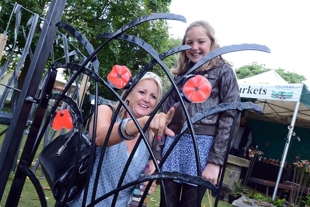 Liz Nicholson, of Stannington, and daughter Emma, aged ten, admiring a decorative metal gate on the Sinclair Metalwork stand in 2013