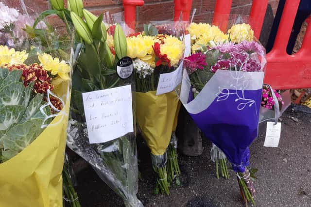 Flowers left for Rita Magni, who was hit by a car and died while waiting for one of her children on Phillimore Road in Darnall, Sheffield