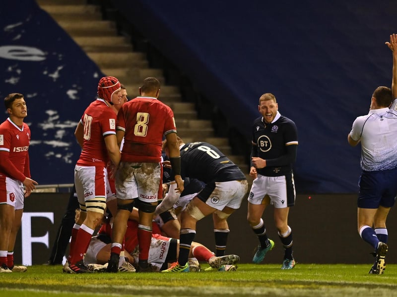 Finn Russell of Scotland celebrates after Stuart Hogg (obscured) touches down for his team's third try during the Guinness Six Nations match between Scotland and Wales at Murrayfield