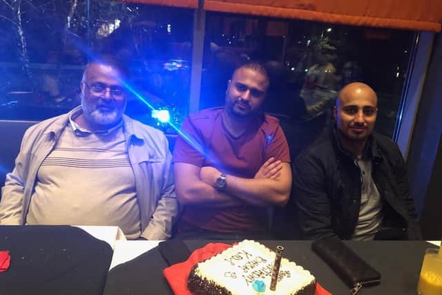 Bashir, with his sons Kamran and Ray at a birthday meal.