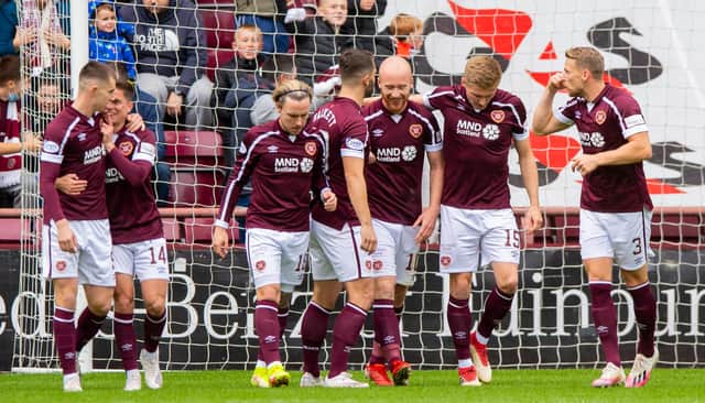 Liam Boyce celebrates his opener with Hearts team-mates. Picture: SNS