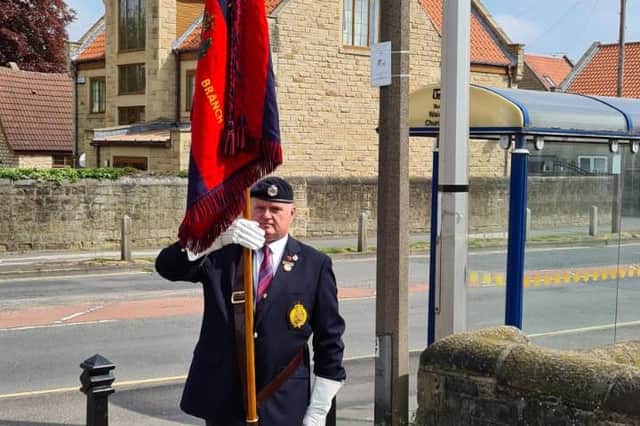 Shaun Kendall, who is the standard-bearer for the Royal Engineers Association, pictured at the Kiveton Park War Memorial at 11.00am on Friday.