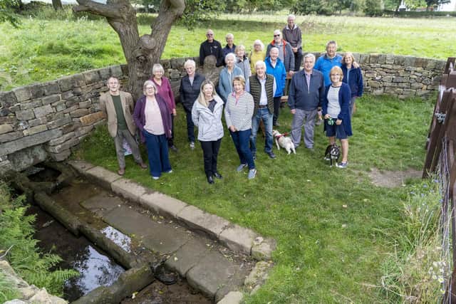 Residents celebrate the restoration of Worrall Well. Picture Scott Merrylees