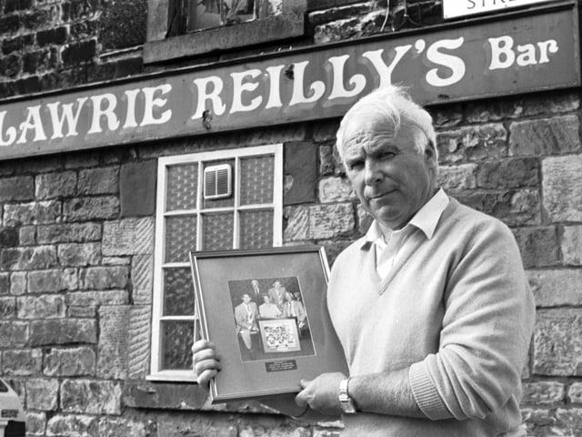Lawrie Reilly said the news that Hearts FC chairman Wallace Mercer planned a takeover of Hibernian was 'unbelievable' in June 1990. Reilly, former Hibs player and one of the Famous Five, is pictured outside his bar in Leith.
