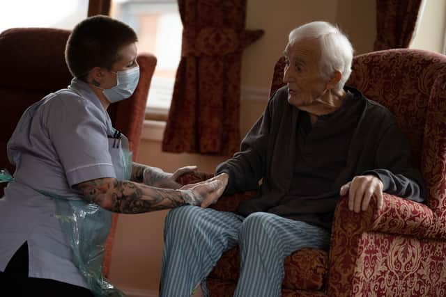 Jack Dodsley, 79, with a carer in PPE at Newfield Nursing Home, Sheffield, April 2020.