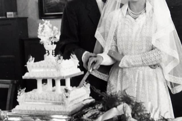 Pete and Madge cutting their cake.