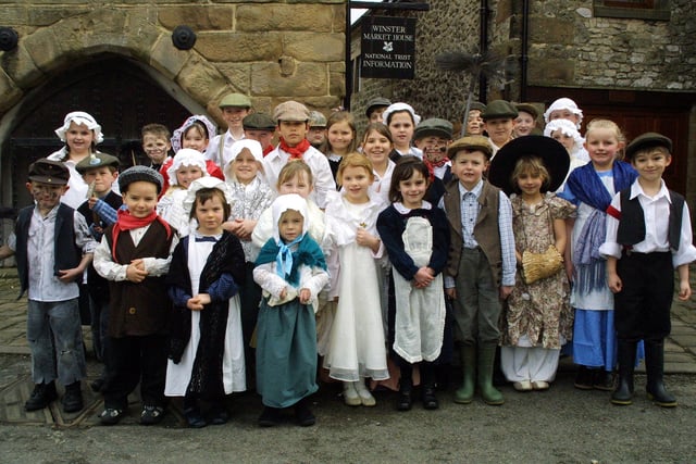 Children from Winster Primary School wear their Victorian costumes as the village celebrates one hundred years of the National Trust caring for properties in the Peak District.