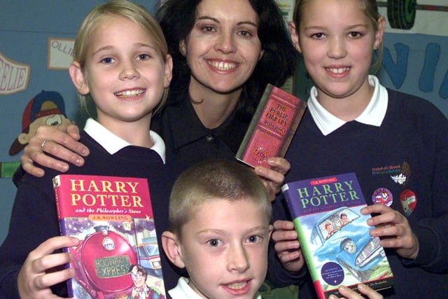 Don Valley MP Caroline Flint presented two Harry Potter books to Doncaster Central Library Children's Library, watched by Hatchell Wood Primary School pupils Mathew Livsey, Lynsey Earley (left) and Amy Smith, all aged ten.The presentation took place at the Central Library in 2000