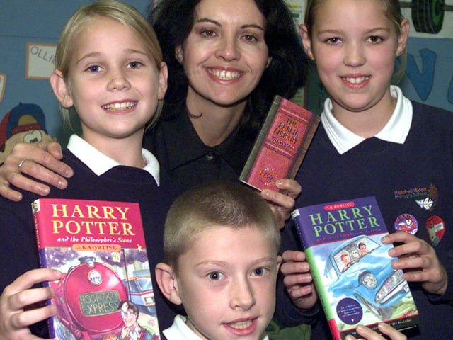 Don Valley MP Caroline Flint presented two Harry Potter books to Doncaster Central Library Children's Library, watched by Hatchell Wood Primary School pupils Mathew Livsey, Lynsey Earley (left) and Amy Smith, all aged ten.The presentation took place at the Central Library in 2000