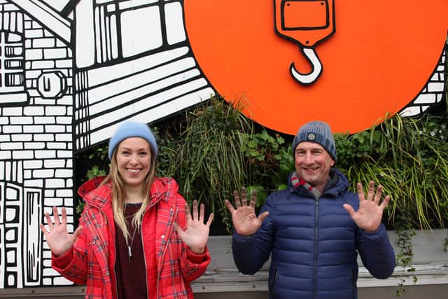 Jo Peel and Nigel Dunnett show their dirty hands after pruning the Growing City installation last month - the plants were covered in grime