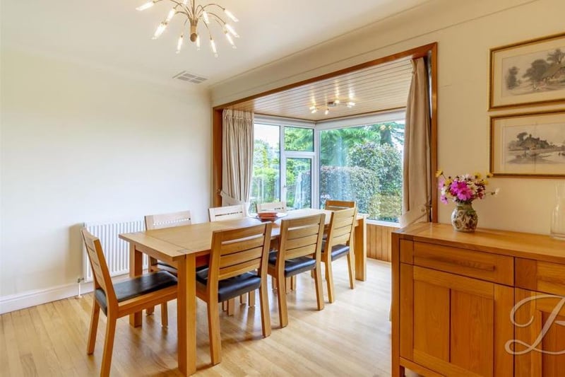 A pleasant dining area in front of big, bright bay windows overlooking the back garden. It has a central-heating radiator.