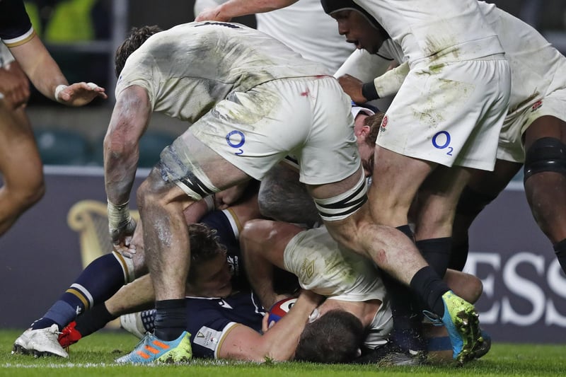 Scotland's Duhan van der Merwe, lower left, rolls over the line to score a try during the Six Nations rugby union international between England and Scotland at Twickenham stadium