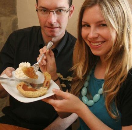 Two friends tucking into a slice of Bakewell Pudding in 2010