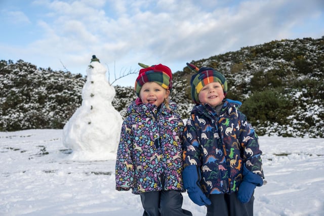 Twins Esme and Murdo Hawthorn 3 with their giant snowman at The Braids
