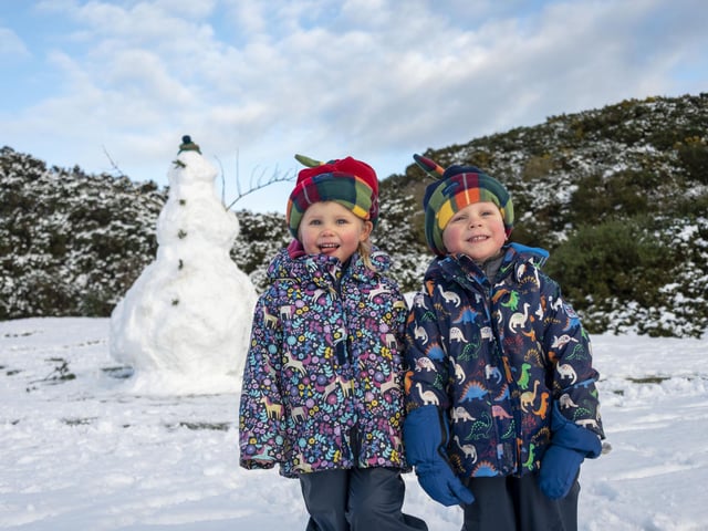 Twins Esme and Murdo Hawthorn 3 with their giant snowman at The Braids