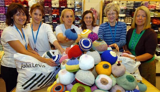 Midwives Sue Cooper, Vanessa Lygo, Maria Barranco-Wadlow and Karen Sabin pictured with John Lewis's Liz Godfrey, organiser of the 'knit a boob' event for breastfeeding support and training in Sheffield, and mum Sian Coleman with baby Emma Holmes, May 2008