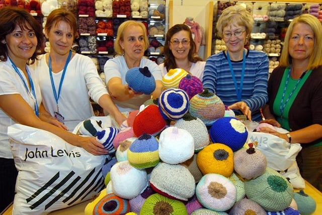 Midwives Sue Cooper, Vanessa Lygo, Maria Barranco-Wadlow and Karen Sabin pictured with John Lewis's Liz Godfrey, organiser of the 'knit a boob' event for breastfeeding support and training in Sheffield, and mum Sian Coleman with baby Emma Holmes, May 2008