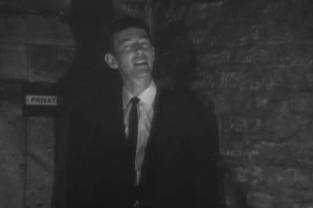 BBC reporter Cathal O'Shannon in front of the secret door that fascinated him so much
